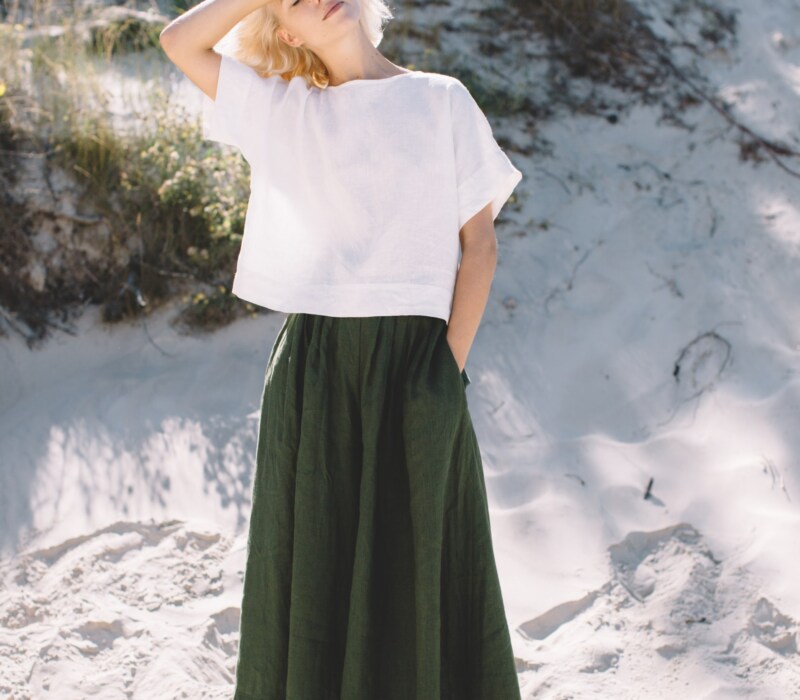 Green linen palazzo and white top set in beach