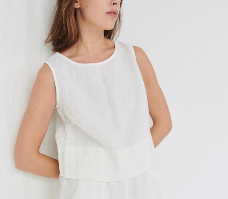 Model wearing white linen crop top