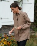 A model wearing a brown oversized linen shirt