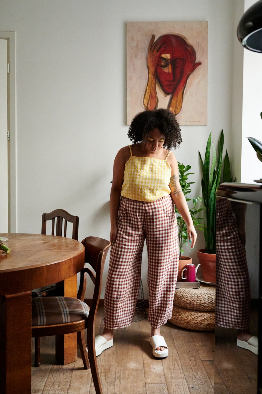 A model in brown gingham linen trousers