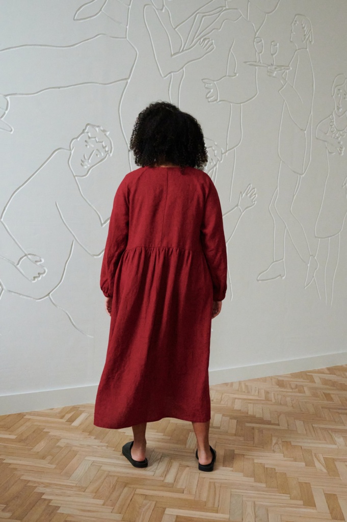model wearing loose fit linen dress in red color