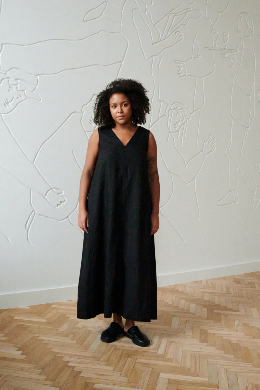 Front of a model in a long black sleeveless linen dress