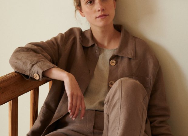 Woman sitting in an all linen outfit wearing ççç and trousers