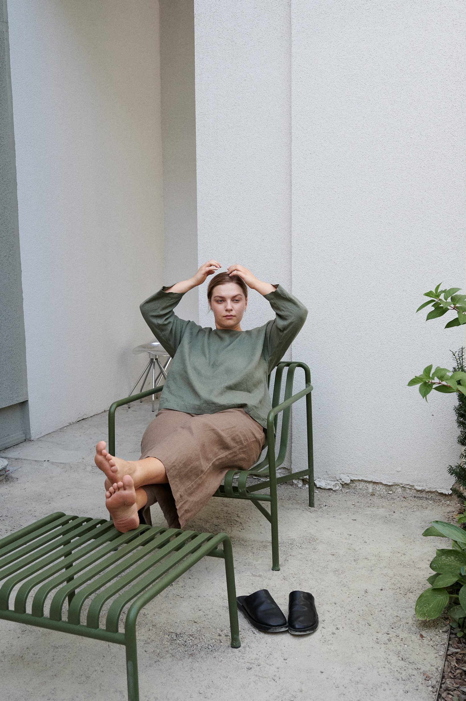 woman wearing linen cacao trousers and pine green linen top