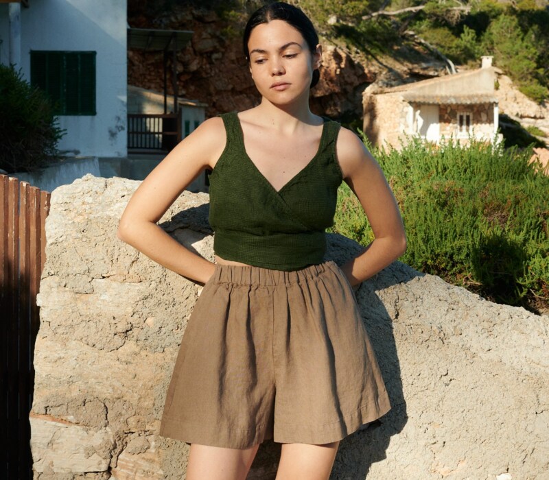 women is wearing brown linen shorts in hot weather