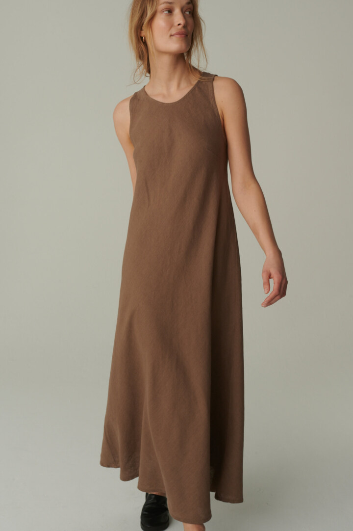 women is wearing bias cut linen dress in brown color