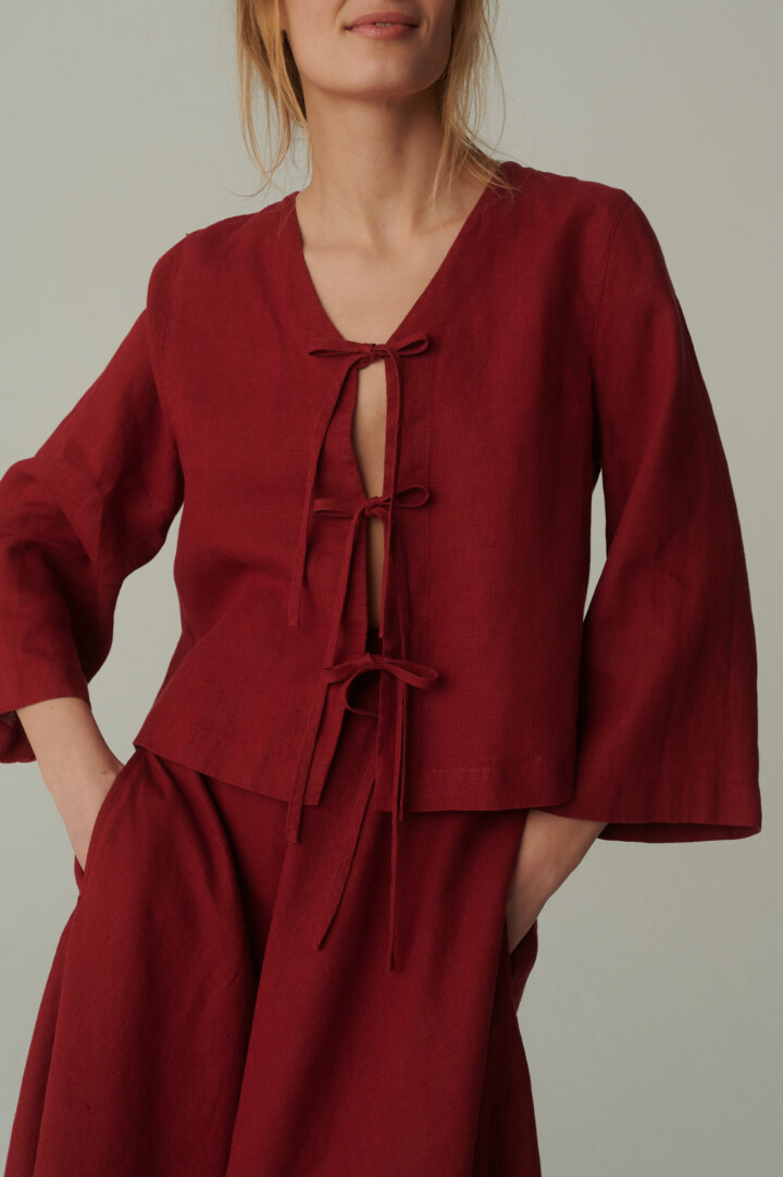 model is wearing red tie front top