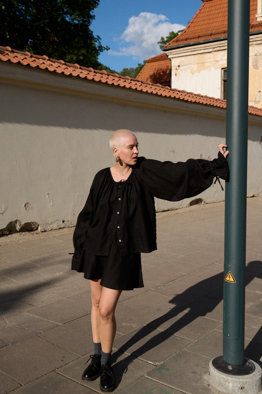 model is wearing black linen blouse