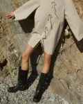 Model wearing a natural cotton-linen blend tunic dress featuring a deep V-neckline, mini length, decorative front tie-bow strings, wide shoulders, flowy sleeves, and a relaxed A-line fit, perfect for effortless summer style