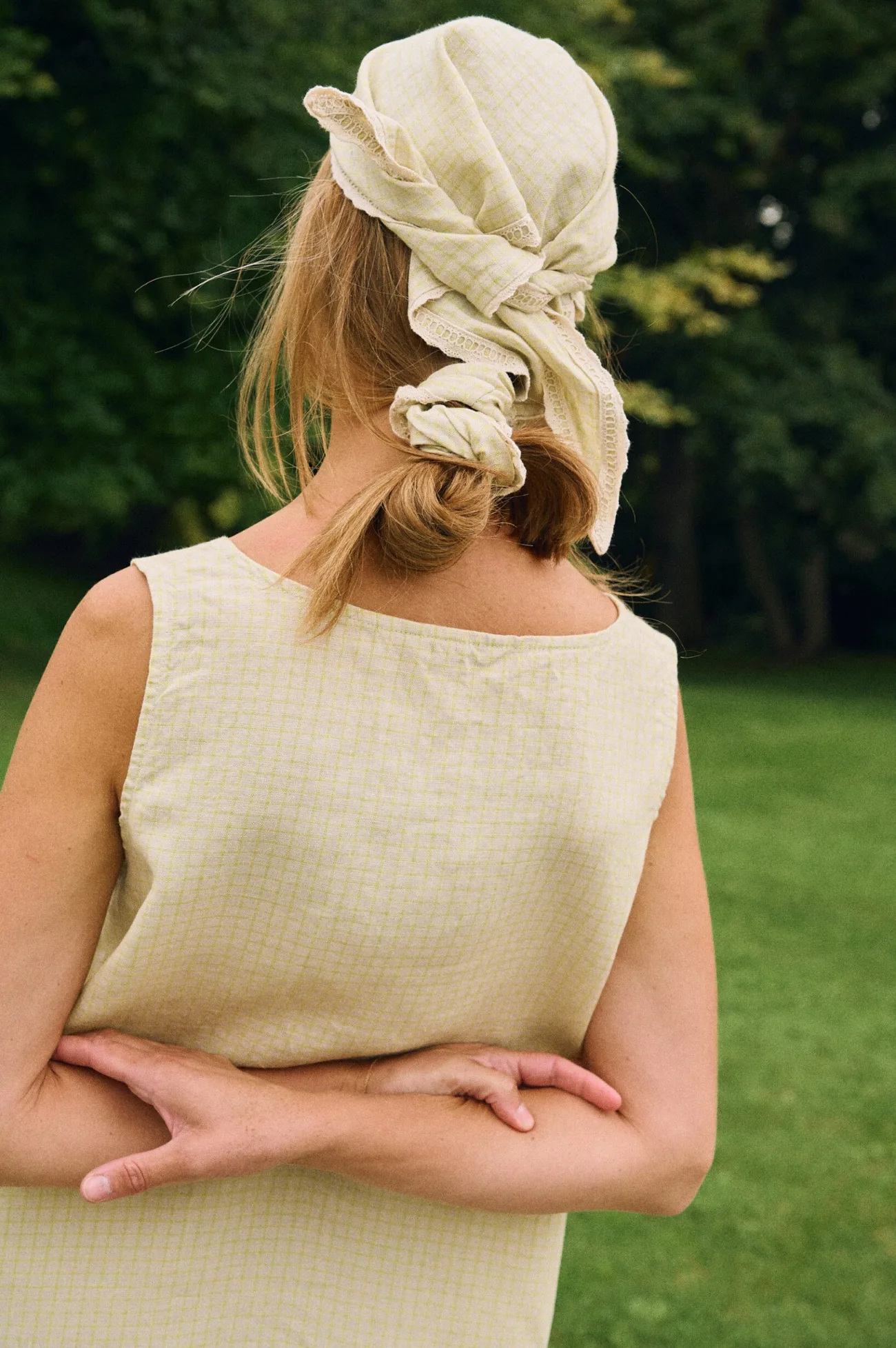 Back view of apple checks linen sleeveless midi dress with matching bandana headscarf