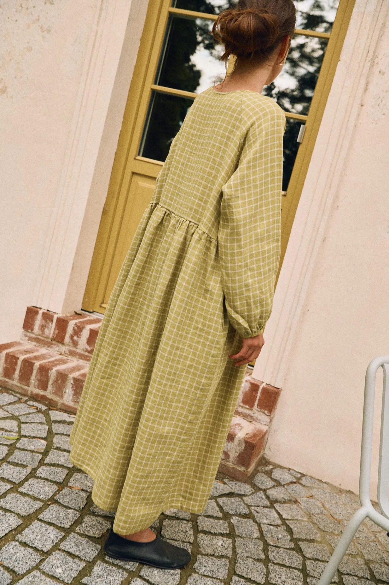 Side angle of pickle checks linen maxi dress showing loose drape and full skirt
