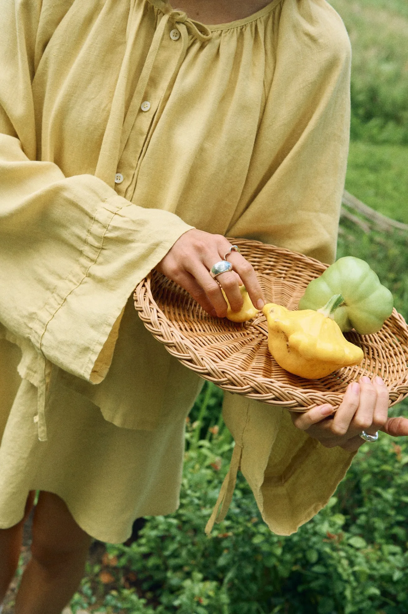 Close-up of butter linen blouse balloon sleeves and button front detail