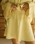 Butter yellow linen mini skirt with flared hem detail and fully elasticated waist