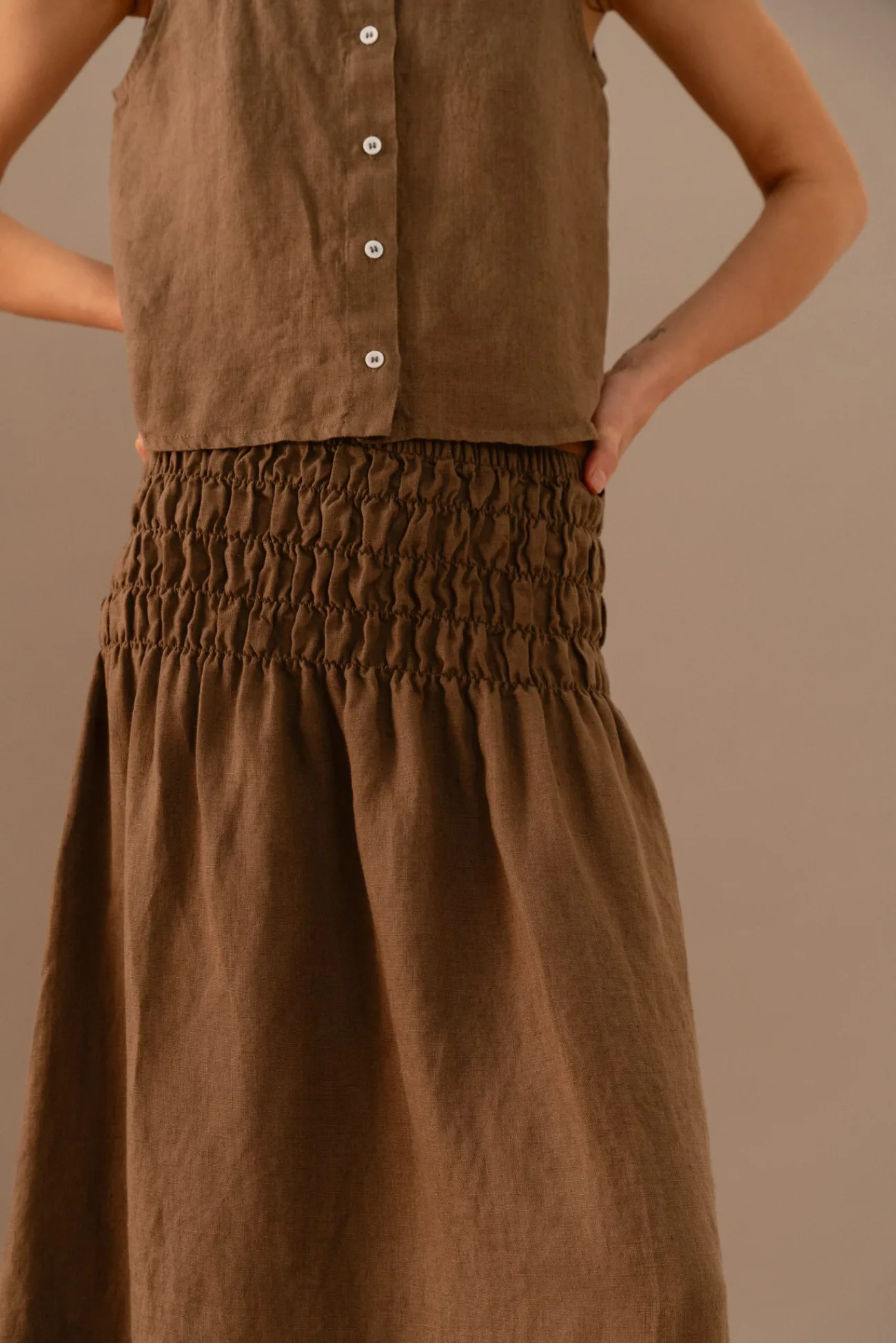 Close-up of cacao linen two piece set highlighting the smocked elastic waistband and button front top