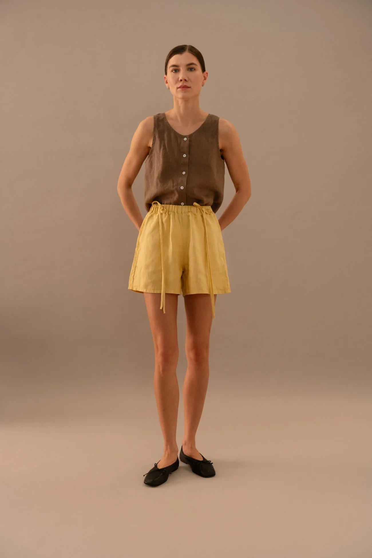 Cacao linen sleeveless button front top paired with butter linen shorts with elastic waistband