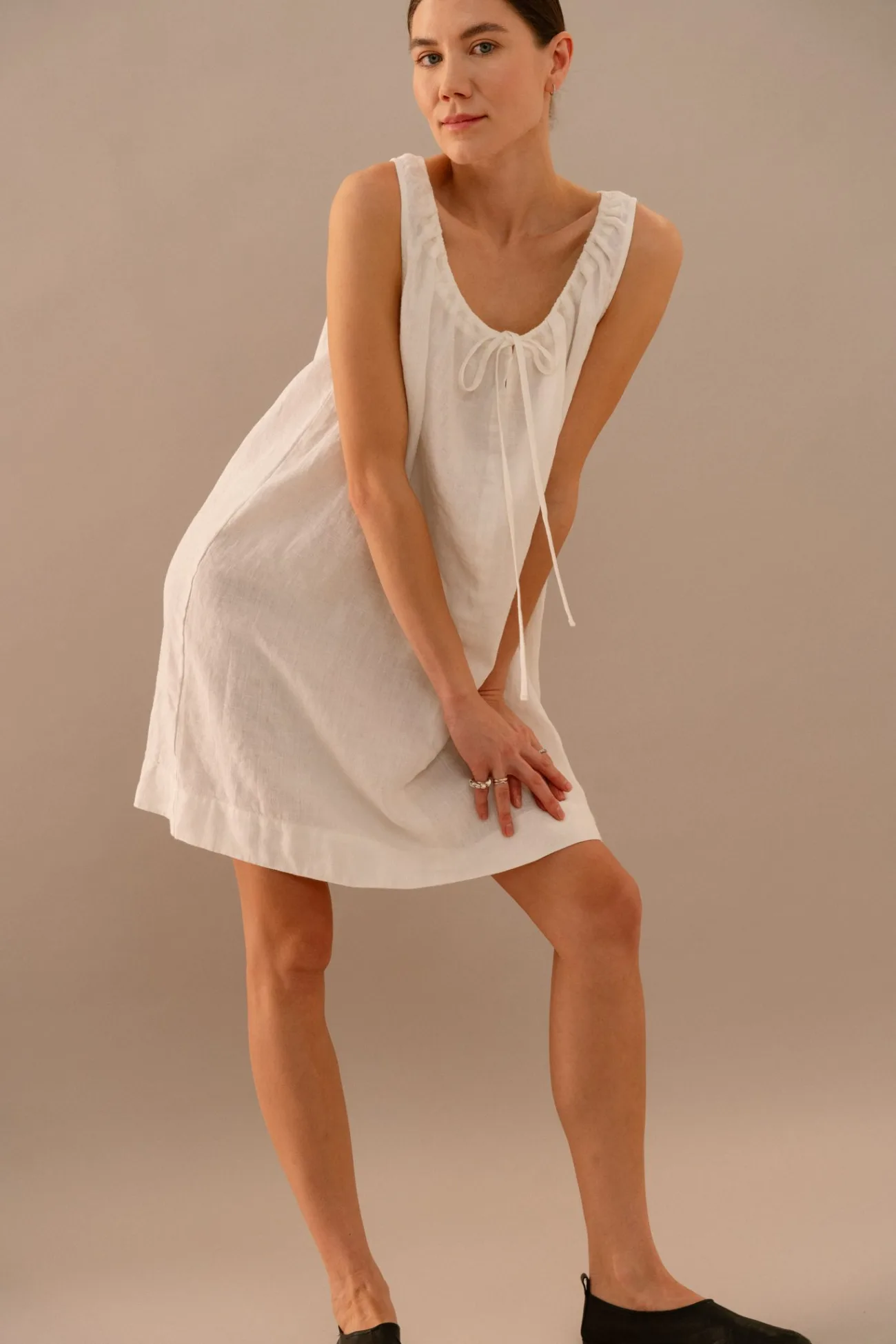 Milky white linen summer dress with airy fit and subtle gathered neckline detail