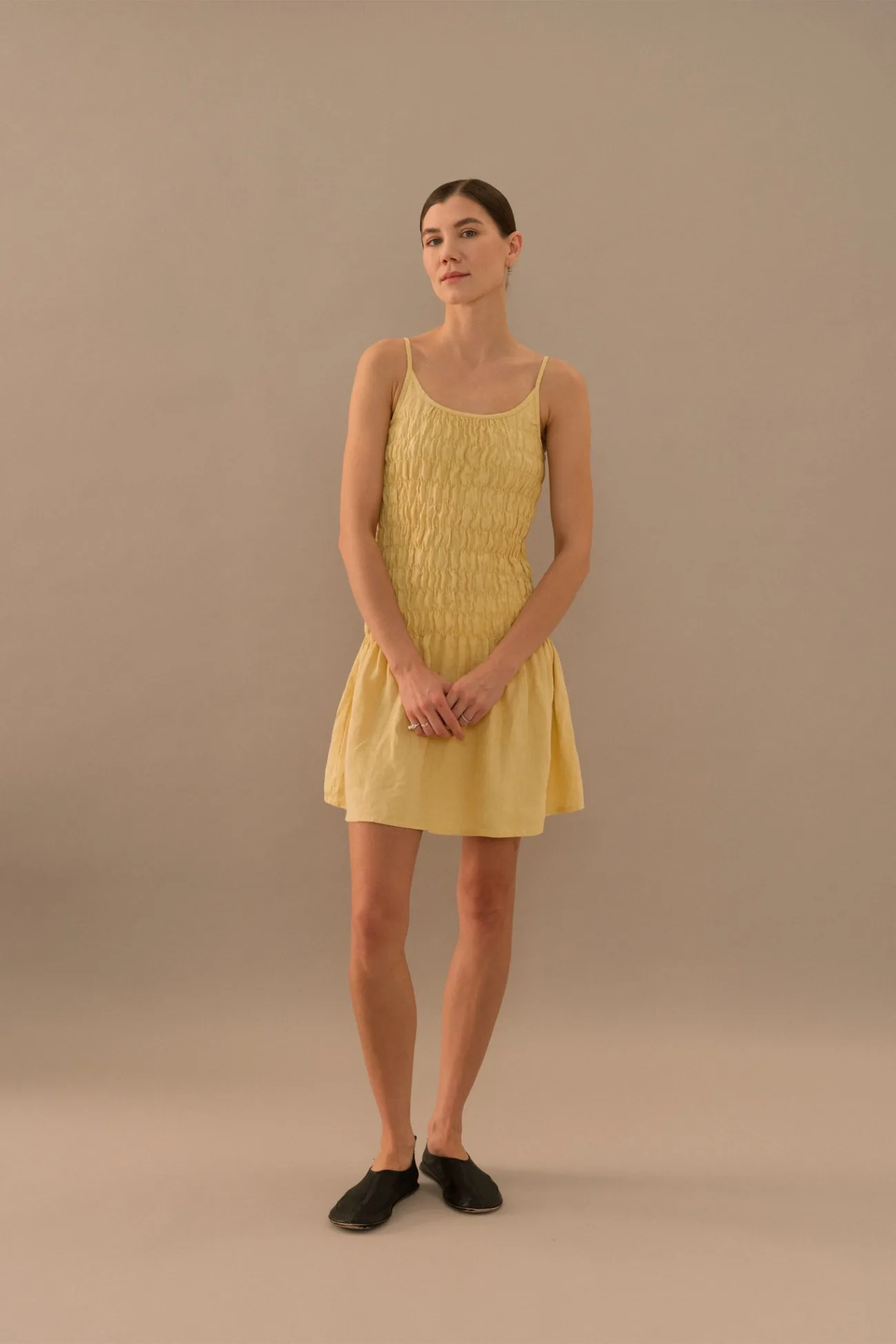Butter yellow linen mini dress with smocked bodice and thin straps