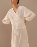 Milky white linen wrap top with side tie and long balloon sleeves paired with tiered maxi skirt
