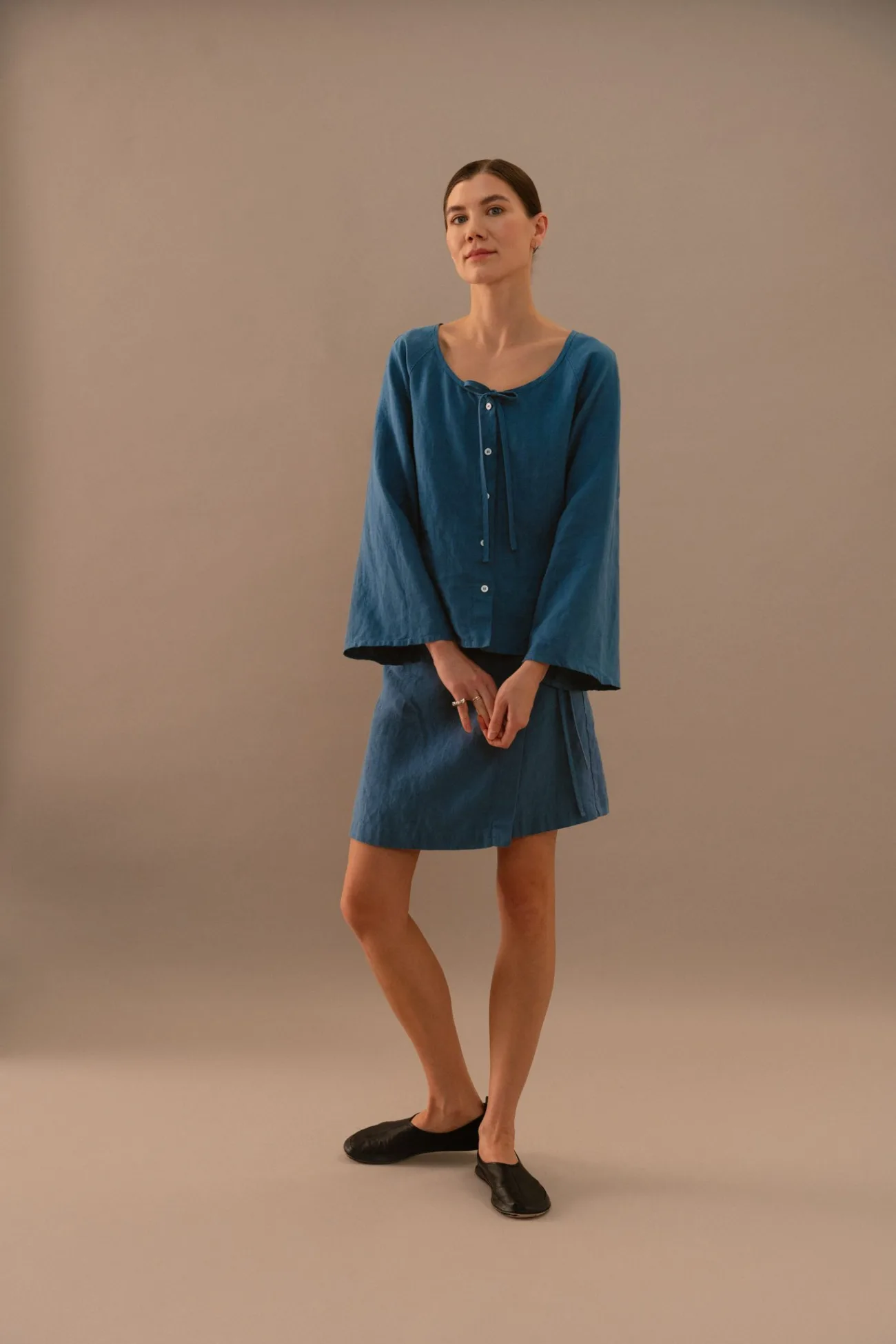 Full length view of stellar blue linen blouse and wrap mini skirt set