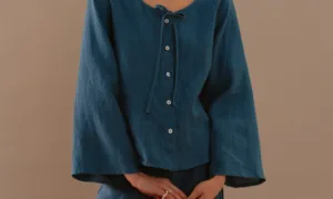 Stellar blue linen blouse with front buttons and tie neckline paired with matching wrap mini skirt