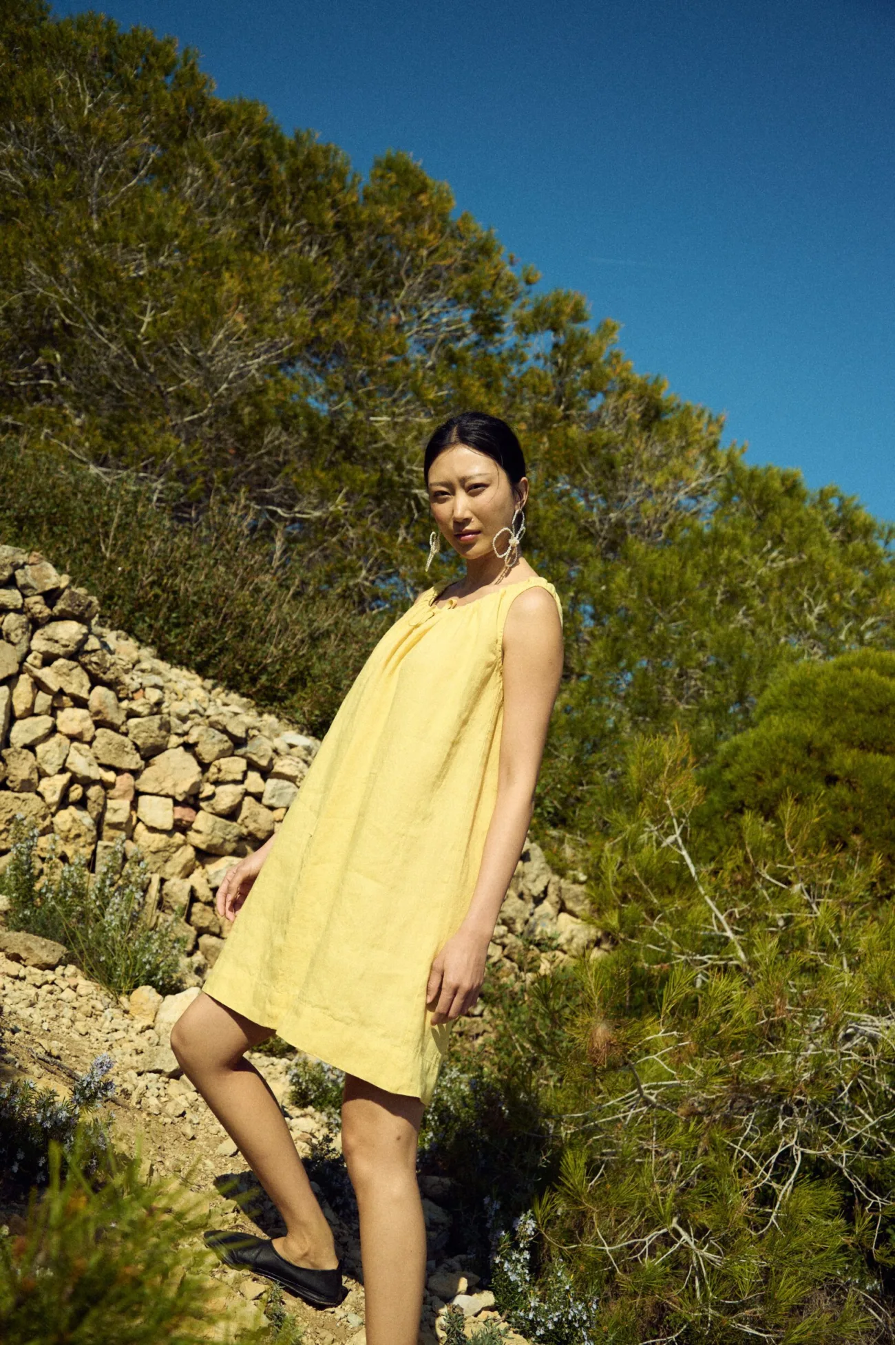 woman wearing butter yellow linen dress in mini length
