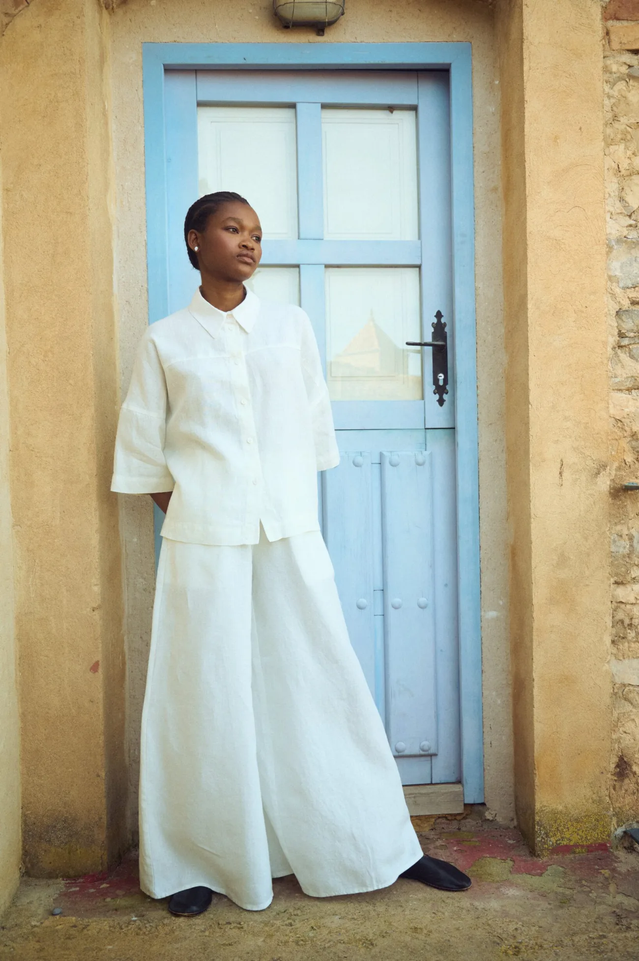 oversized white linen shirt styled with wide linen culottes