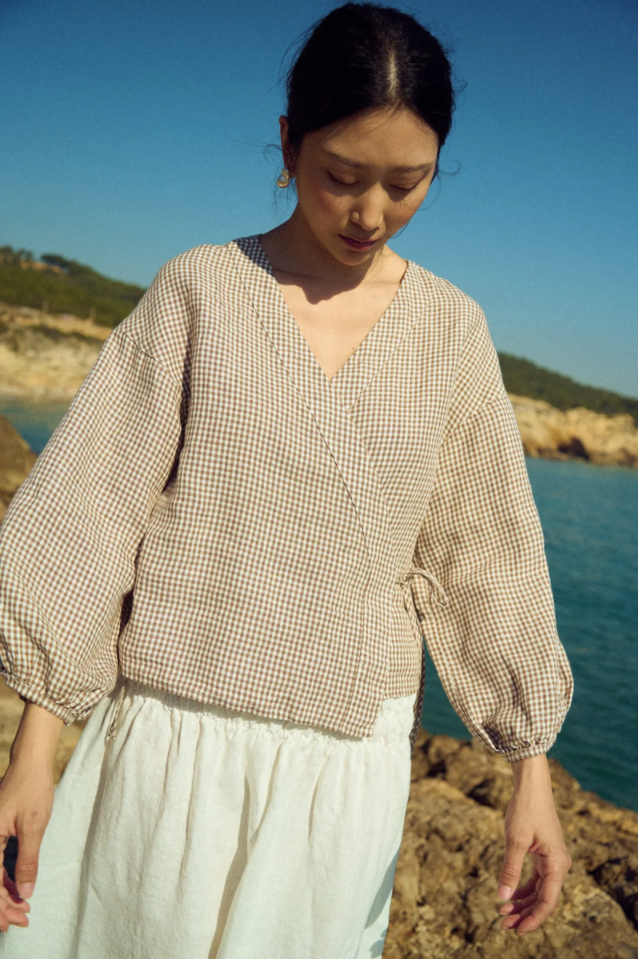 Linen wrap top in brown gingham with relaxed fit and softly gathered sleeves
