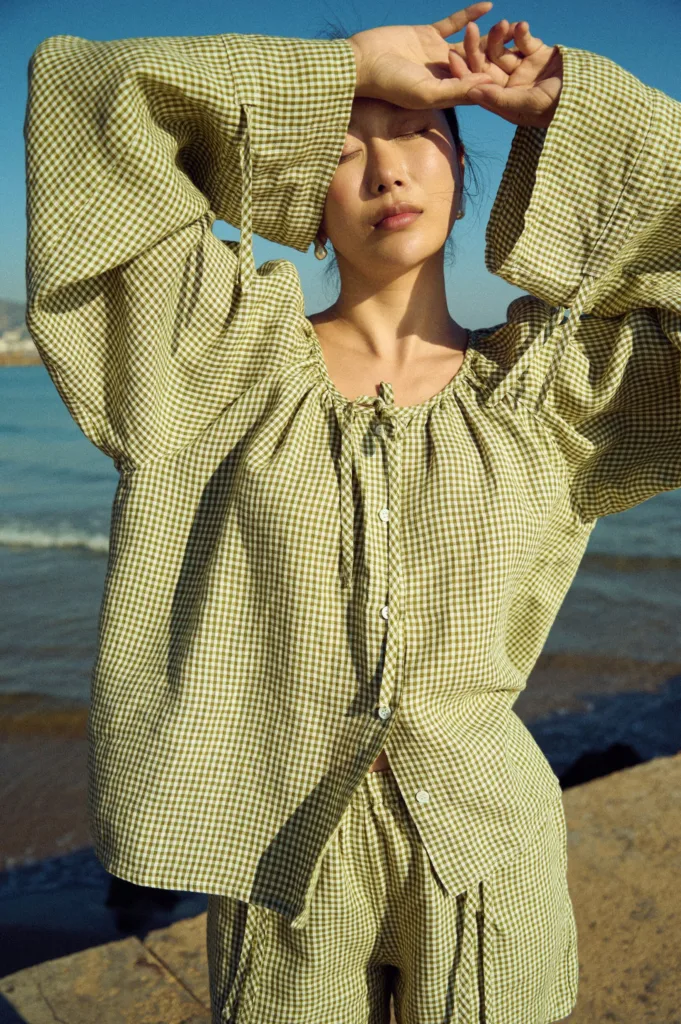 Green mini gingham linen top with gentle gathers at the neckline and wide sleeves, styled with linen shorts
