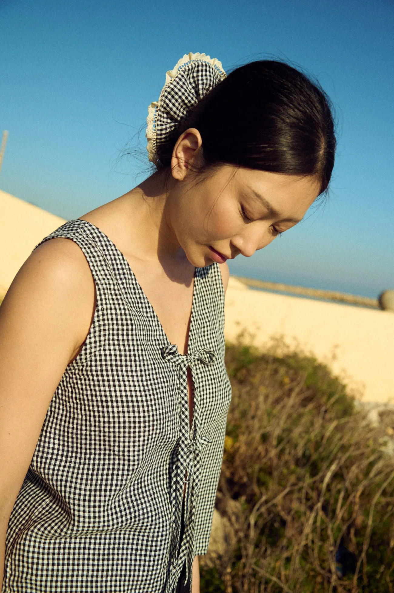 Linen scrunchie in black mini gingham with ruffled shape and lace trim detail