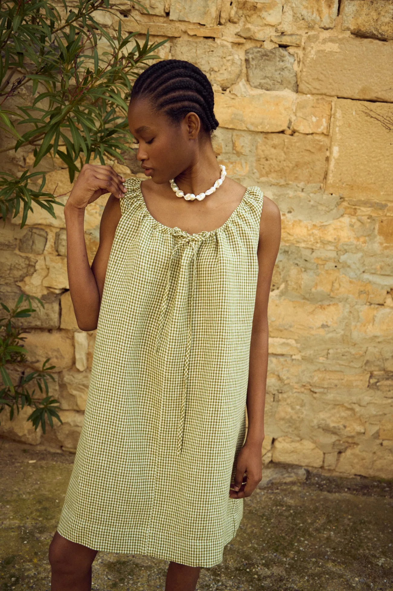 Relaxed fit green mini gingham linen dress with adjustable tie neckline and airy silhouette