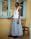 Blue gingham linen skirt with a gathered tier and soft volume, paired with a white linen top