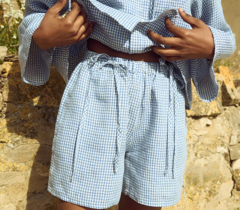 Blue mini gingham linen shorts with relaxed fit and softly gathered elastic waist