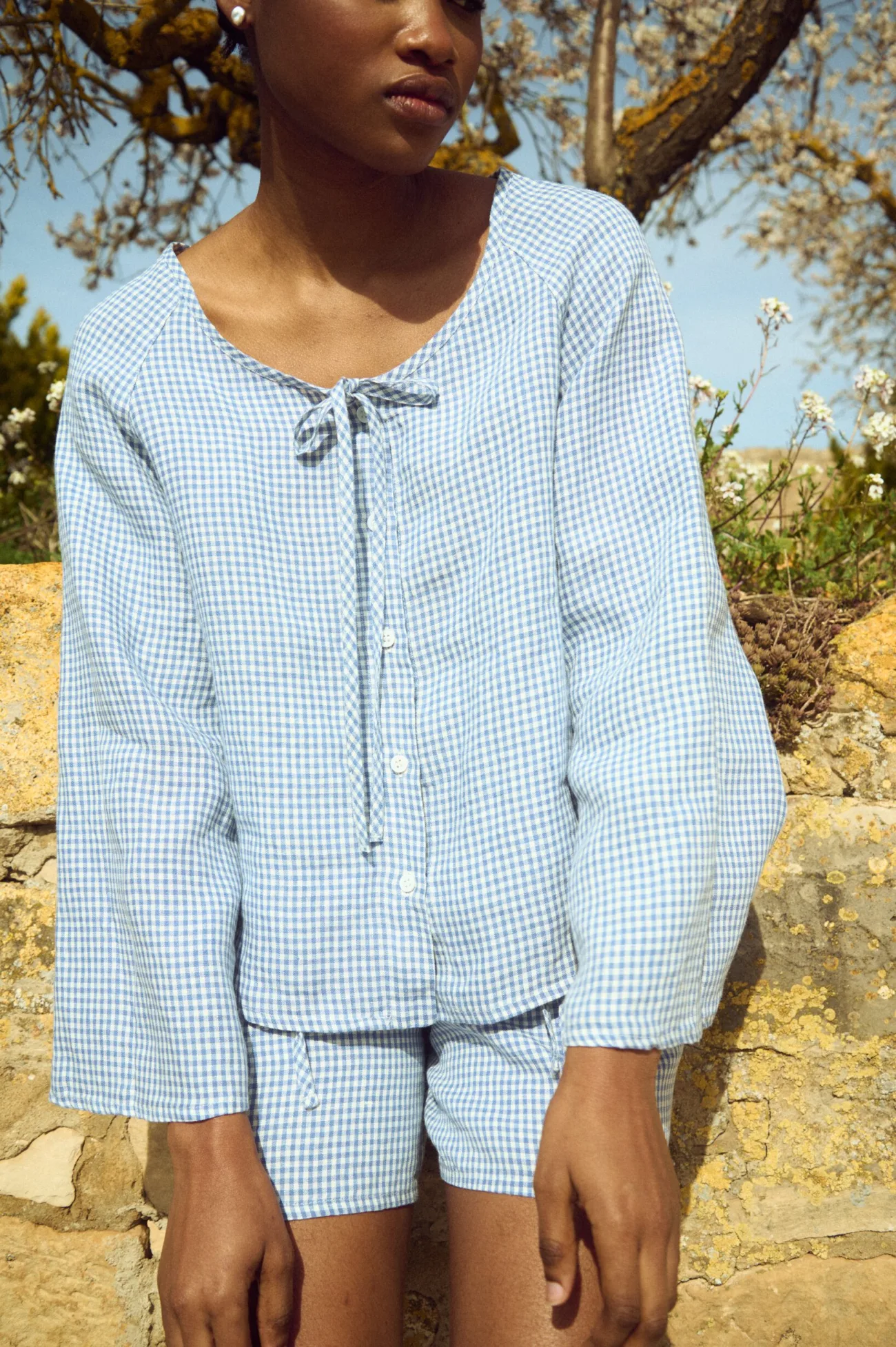 Blue mini gingham linen blouse with relaxed fit, shell button fastening and softly flared sleeves