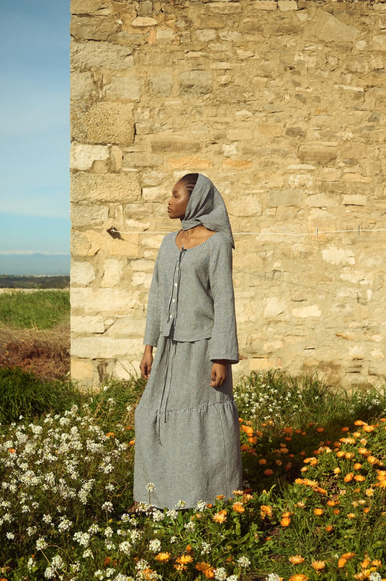 Black gingham linen top with relaxed fit and wide sleeves, paired with a matching gingham skirt and headscarf