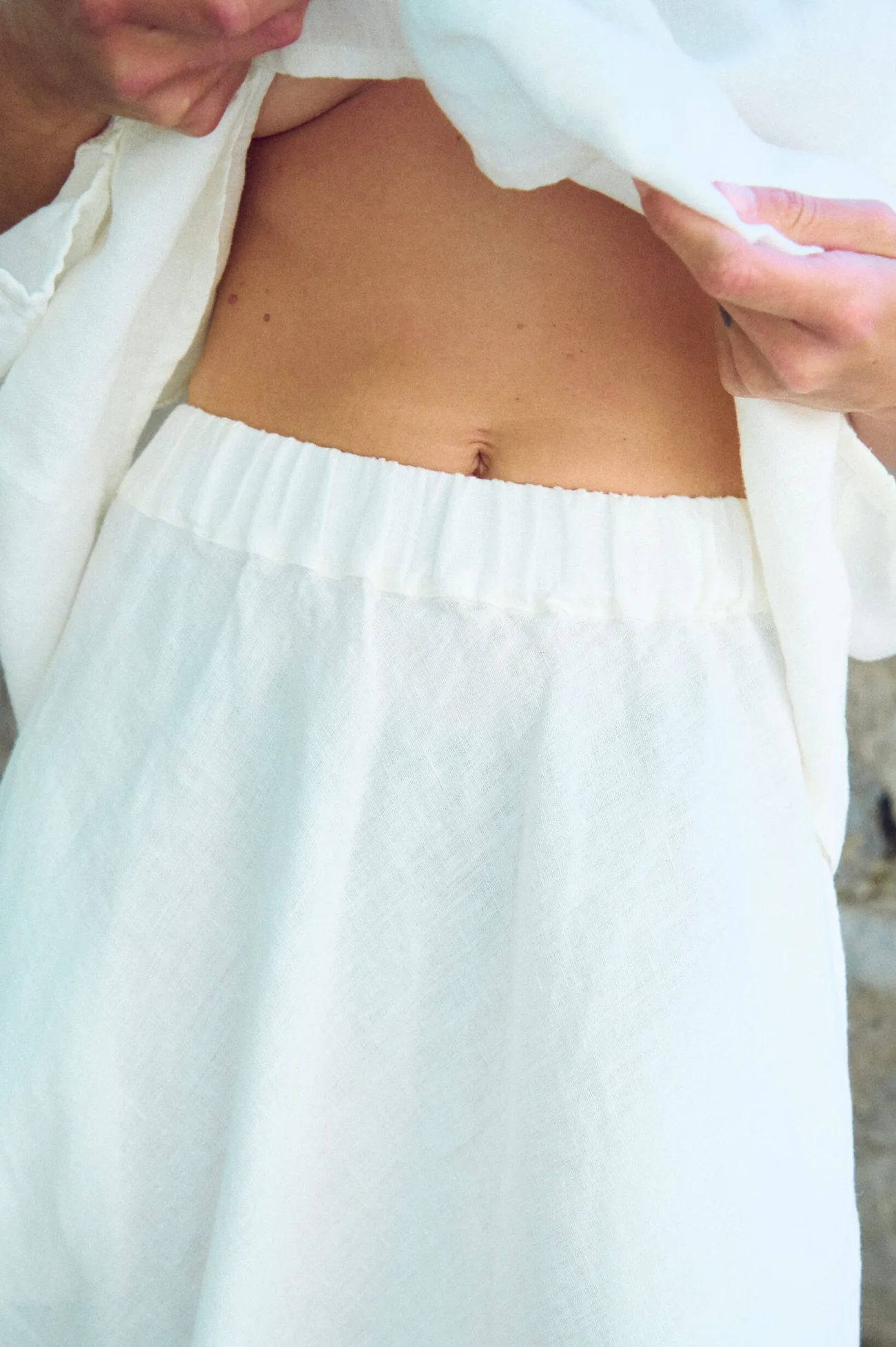 close up of white linen skirt's waistline in maxi length