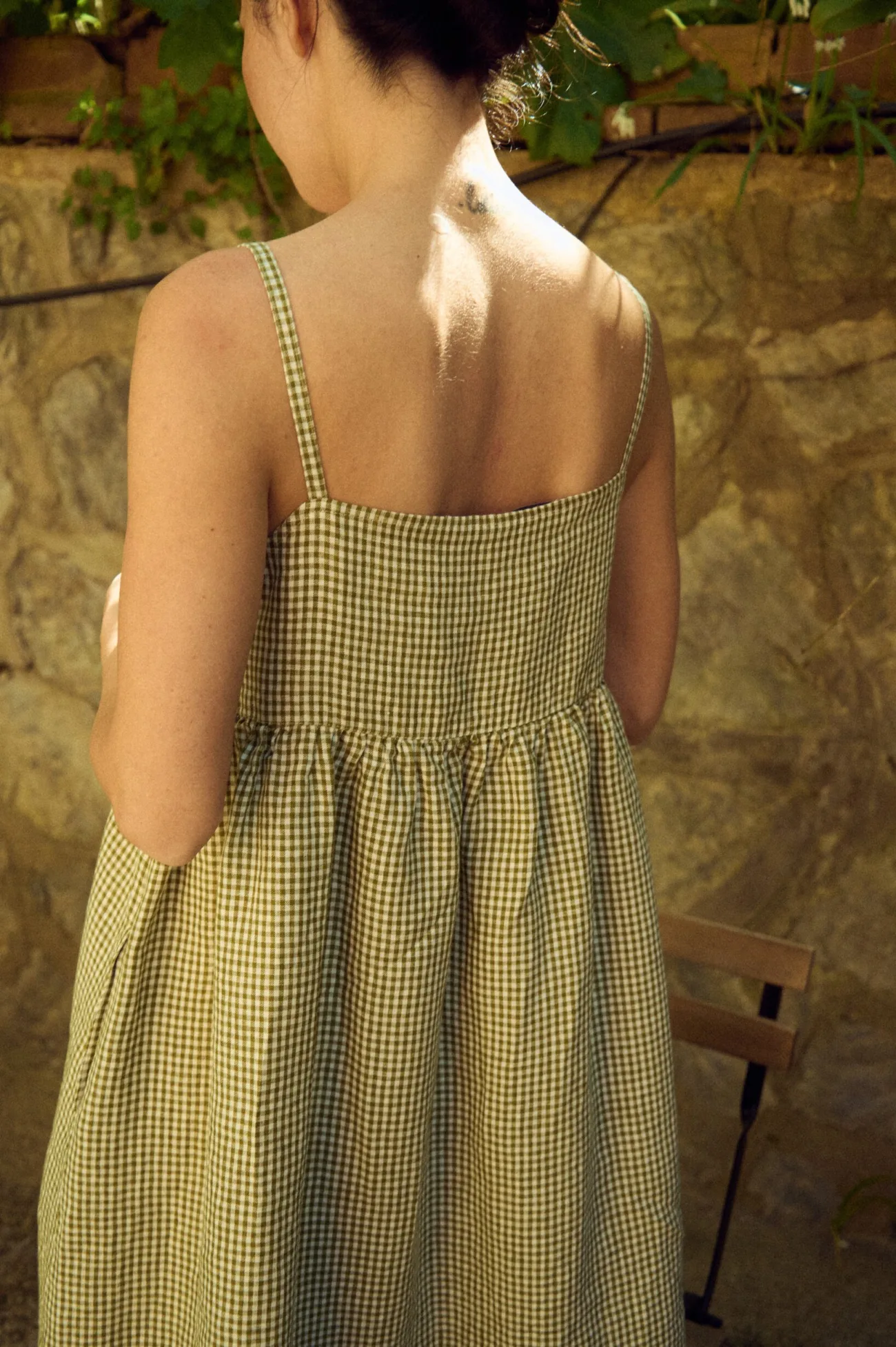 the back view of midi summer gingham strap dress in green and white checks