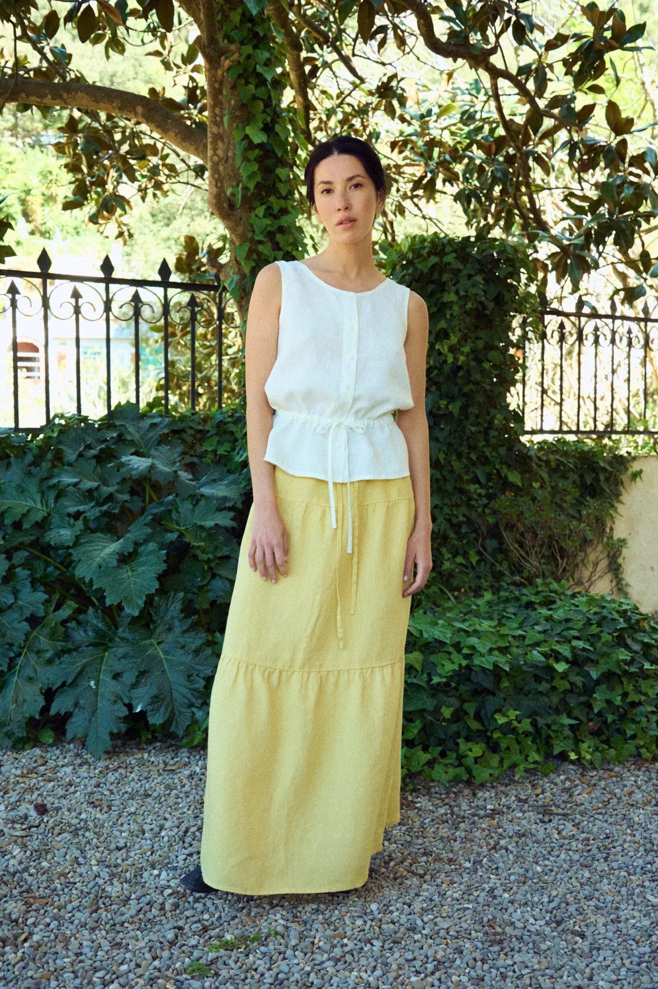 round neckline sleeveless blouse in white linen paired with yellow gathered skirt