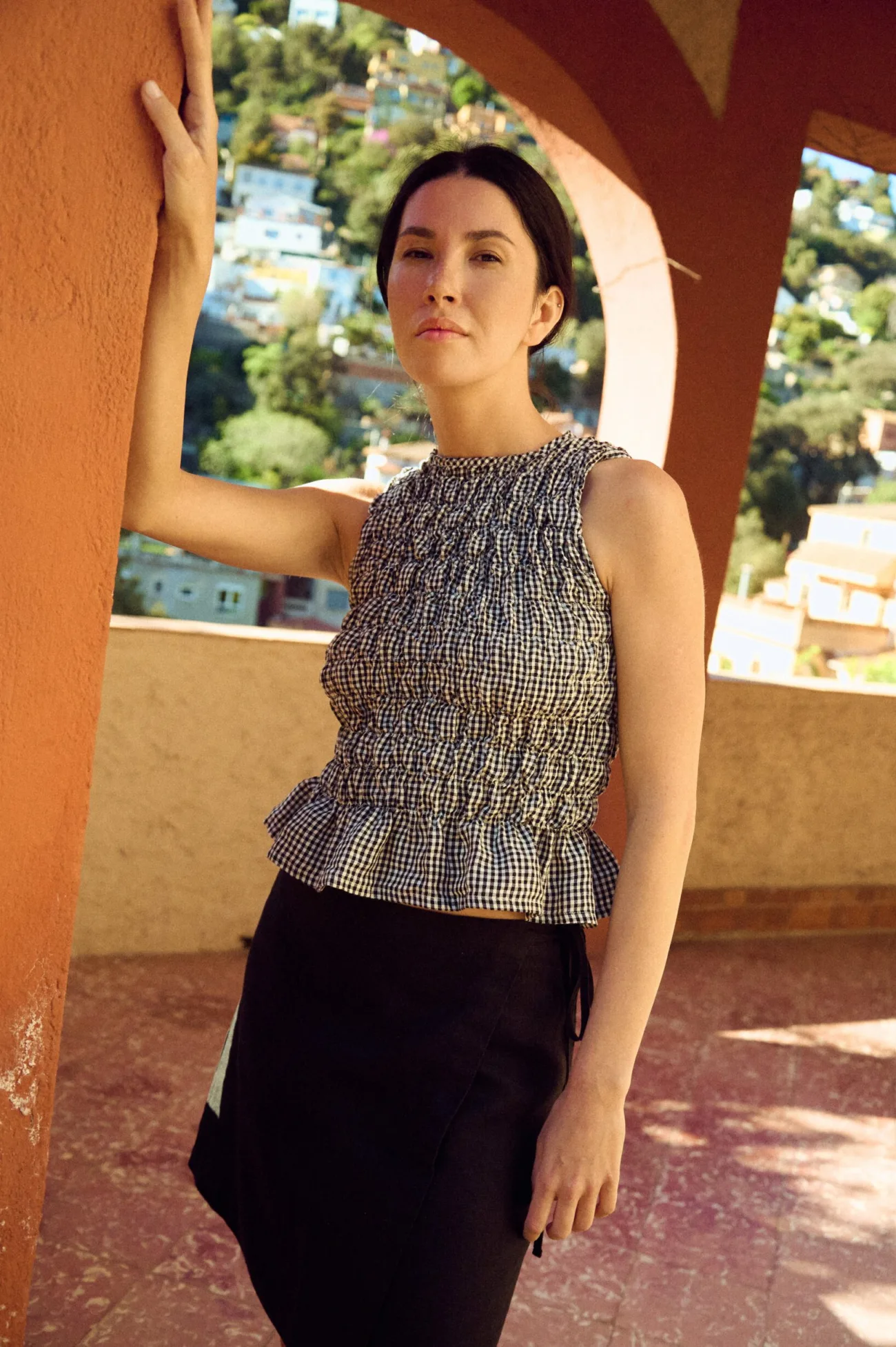 black and white gingham linen top with smocked design styled with mini black skirt