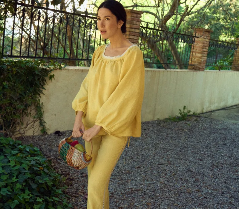 Straight fit linen drawstring trousers with side ties and lace detail. Minimal design without pockets.
