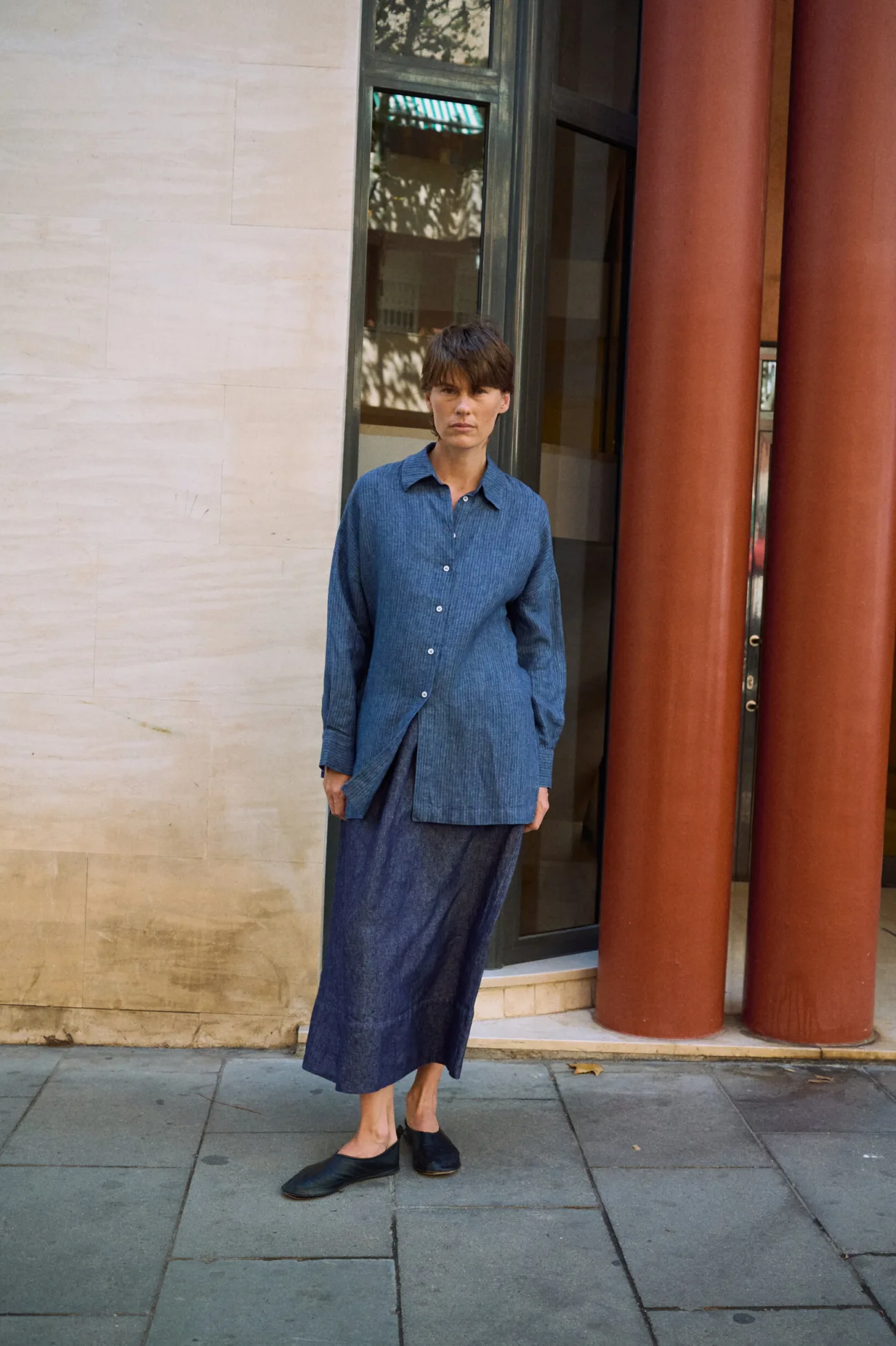 Denim linen maxi skirt paired with a loose blue striped linen button-up shirt